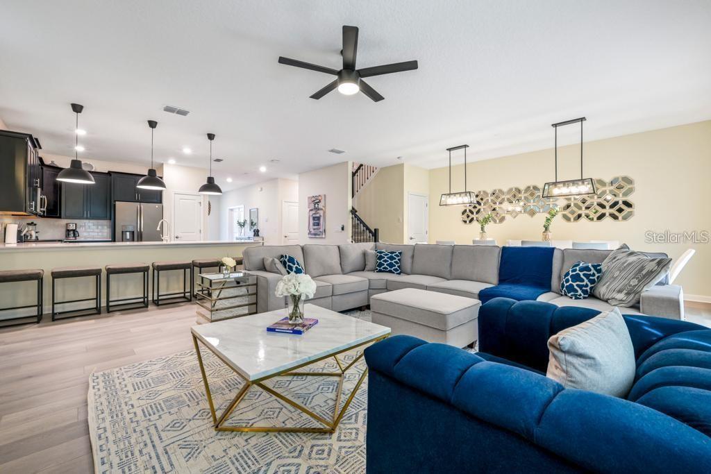 4532 Target Boulevard Kissimmee, FL 34746 - Photo 21 of 52 a living room with furniture kitchen view and a chandelier