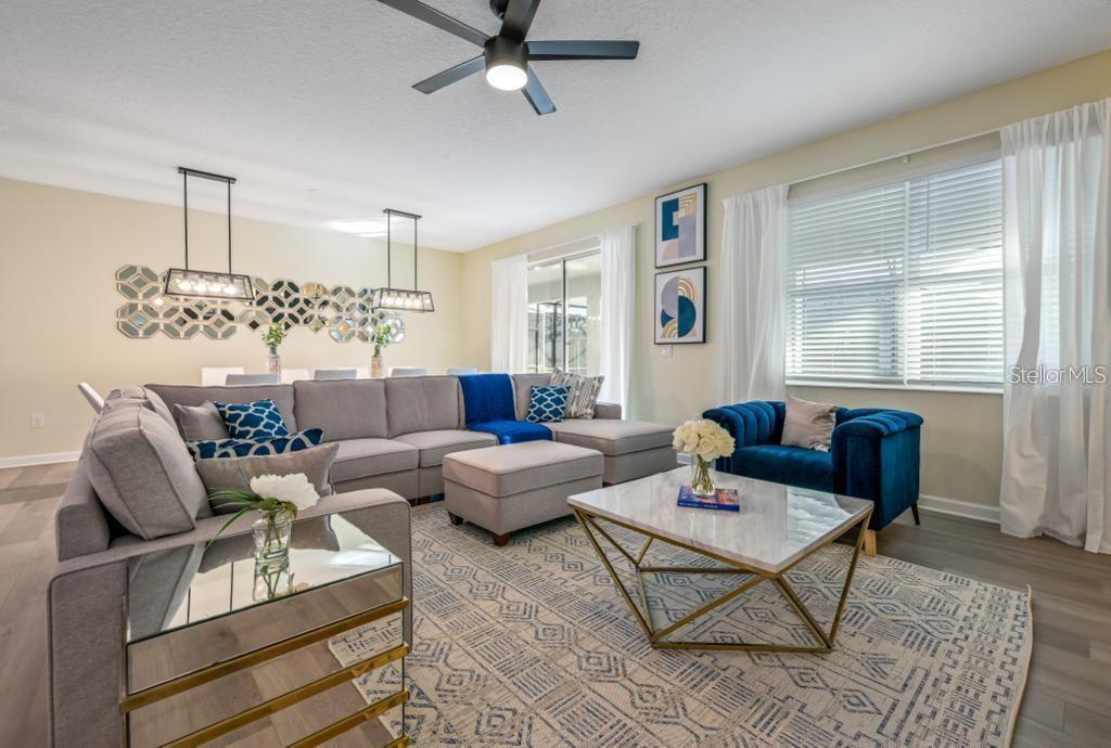 4532 Target Boulevard Kissimmee, FL 34746 - Photo 22 of 52 a living room with furniture and a chandelier