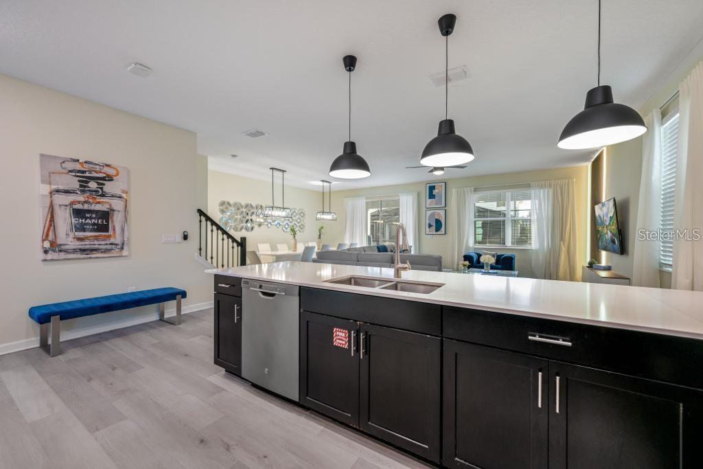 4532 Target Boulevard Kissimmee, FL 34746 - Photo 30 of 52 a kitchen with stainless steel appliances a sink stove and wooden floor