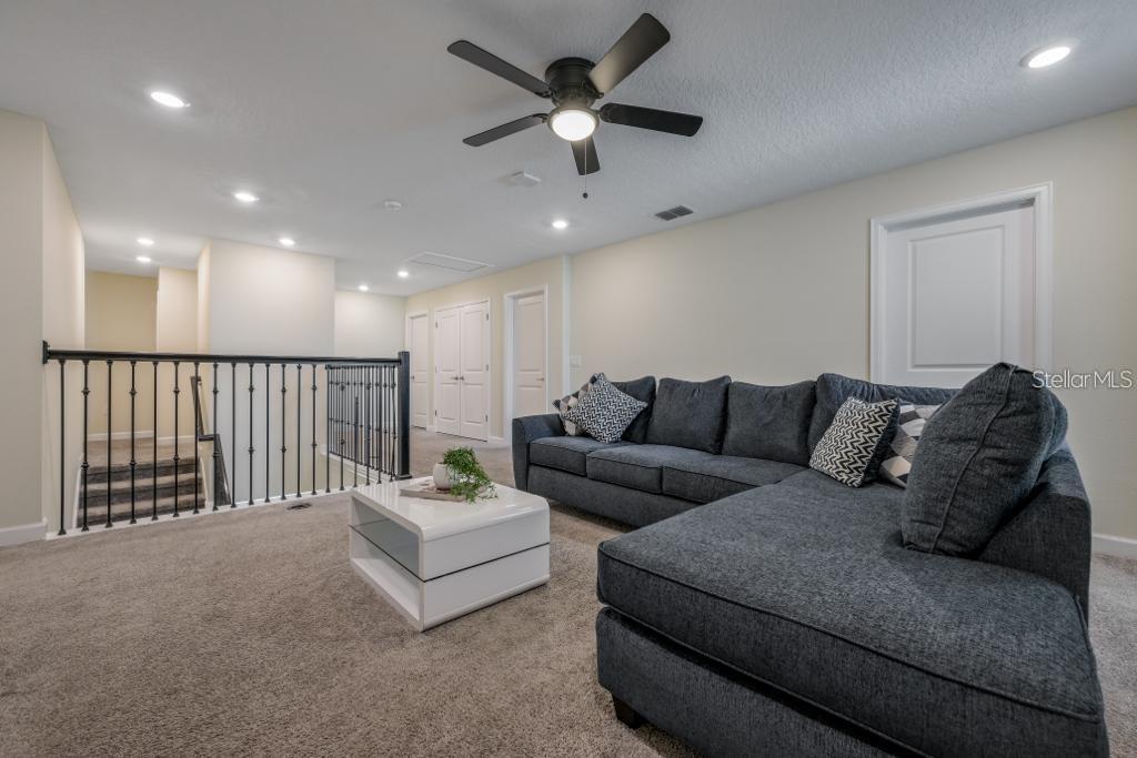 4532 Target Boulevard Kissimmee, FL 34746 - Photo 31 of 52 a living room with furniture and a ceiling fan