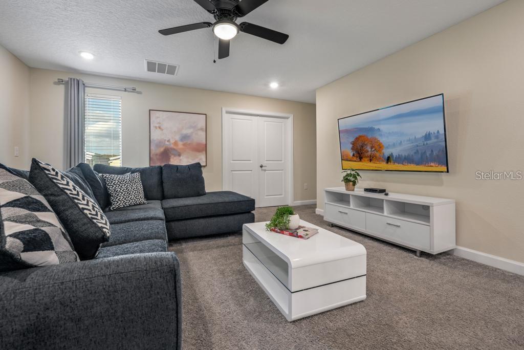 4532 Target Boulevard Kissimmee, FL 34746 - Photo 32 of 52 a living room with furniture and a flat screen tv
