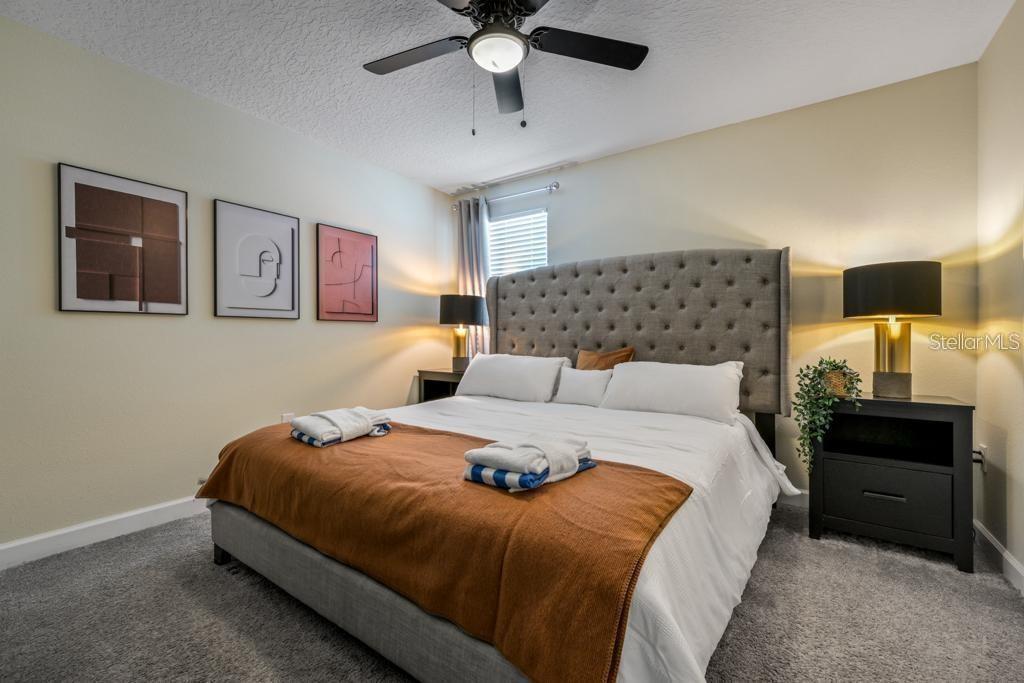 4532 Target Boulevard Kissimmee, FL 34746 - Photo 36 of 52 a bedroom with a bed and a chandelier