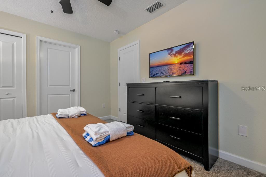 4532 Target Boulevard Kissimmee, FL 34746 - Photo 37 of 52 a bedroom with a bed and the dresser