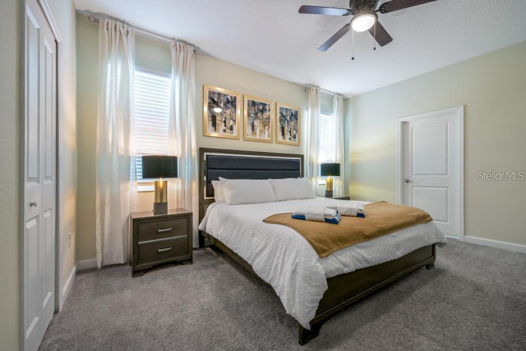 4532 Target Boulevard Kissimmee, FL 34746 - Photo 38 of 52 a bedroom with a bed and a chandelier