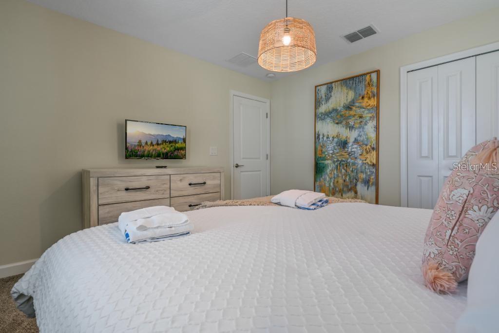 4532 Target Boulevard Kissimmee, FL 34746 - Photo 40 of 52 a bedroom with a bed and a flat screen tv