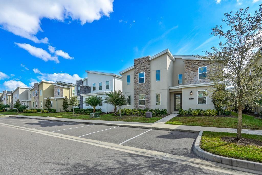4532 Target Boulevard Kissimmee, FL 34746 - Photo 4 of 52 a view of a white house with a big yard and potted plants and large trees