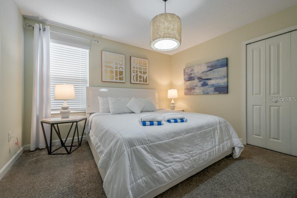 4532 Target Boulevard Kissimmee, FL 34746 - Photo 42 of 52 a bedroom with a bed and a chandelier
