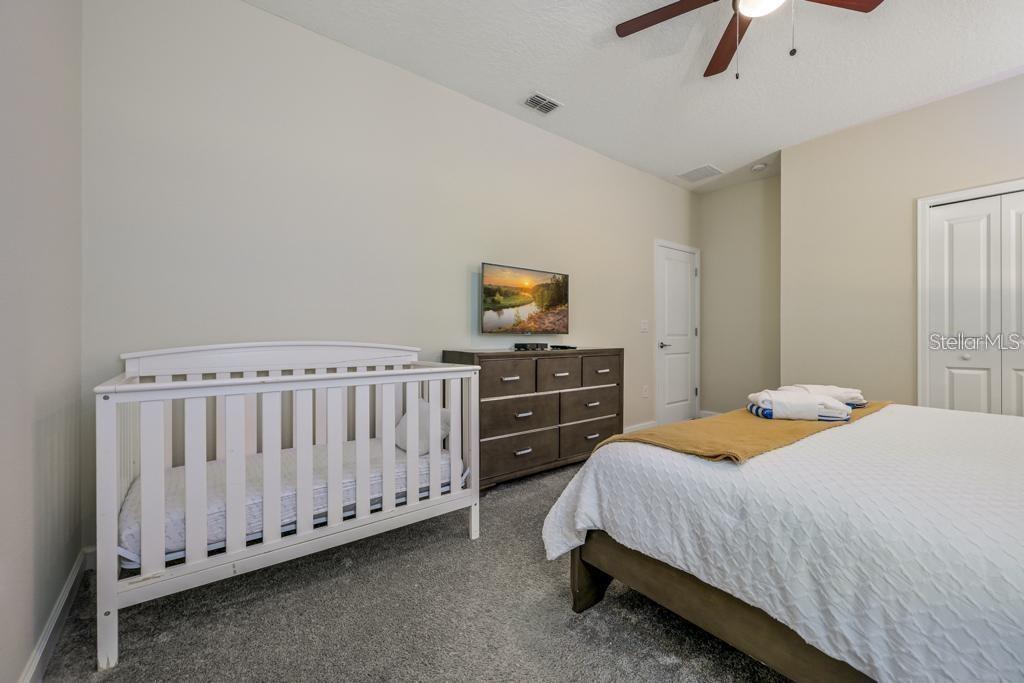 4532 Target Boulevard Kissimmee, FL 34746 - Photo 44 of 52 a bedroom with a bed and a tv