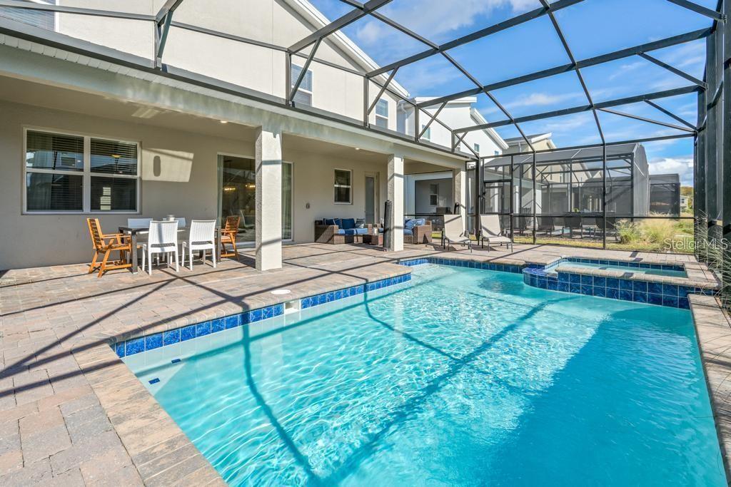 4532 Target Boulevard Kissimmee, FL 34746 - Photo 47 of 52 a living room with patio furniture and a dining table