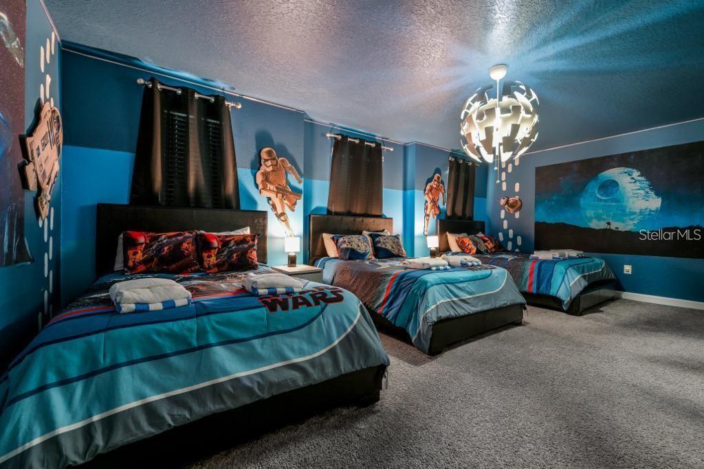 4532 Target Boulevard Kissimmee, FL 34746 - Photo 7 of 52 a bedroom with bed and a chandelier