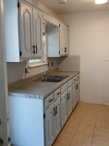a kitchen with a sink and cabinets