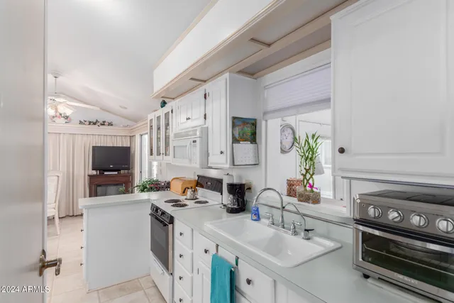 a kitchen with a sink stove and cabinets