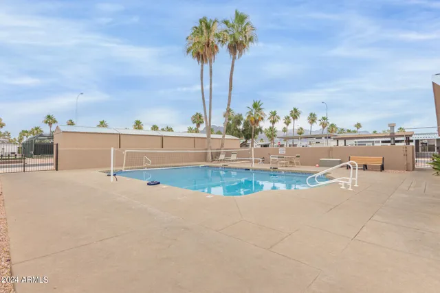 a view of a swimming pool with an outdoor seating