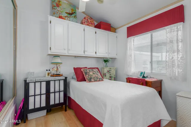 a bedroom with a bed and a window