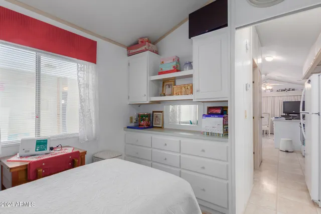 a bedroom with a bed and a cabinets