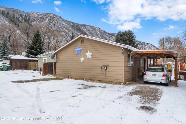 a view of a house with a snow in the yard