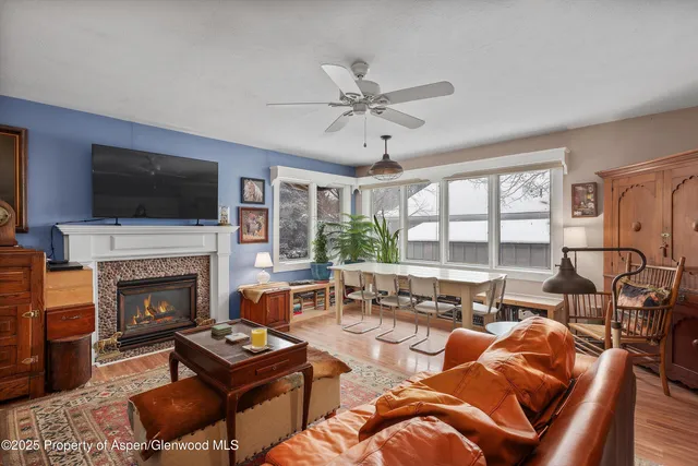 a living room with furniture a flat screen tv and a fireplace
