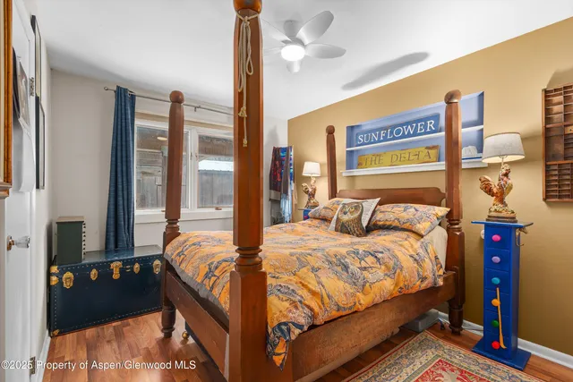 a view of a workspace with furniture and wooden floor