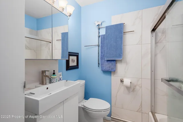 a bathroom with a sink a mirror and shower