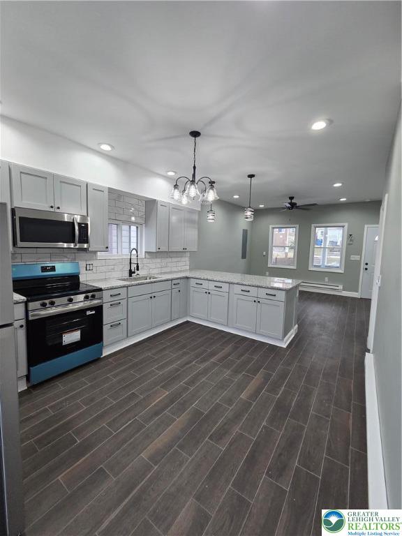 253 East Abbott Street Lansford, PA 18232 - Photo 12 of 43 a kitchen with stainless steel appliances kitchen island granite countertop a stove top oven and sink