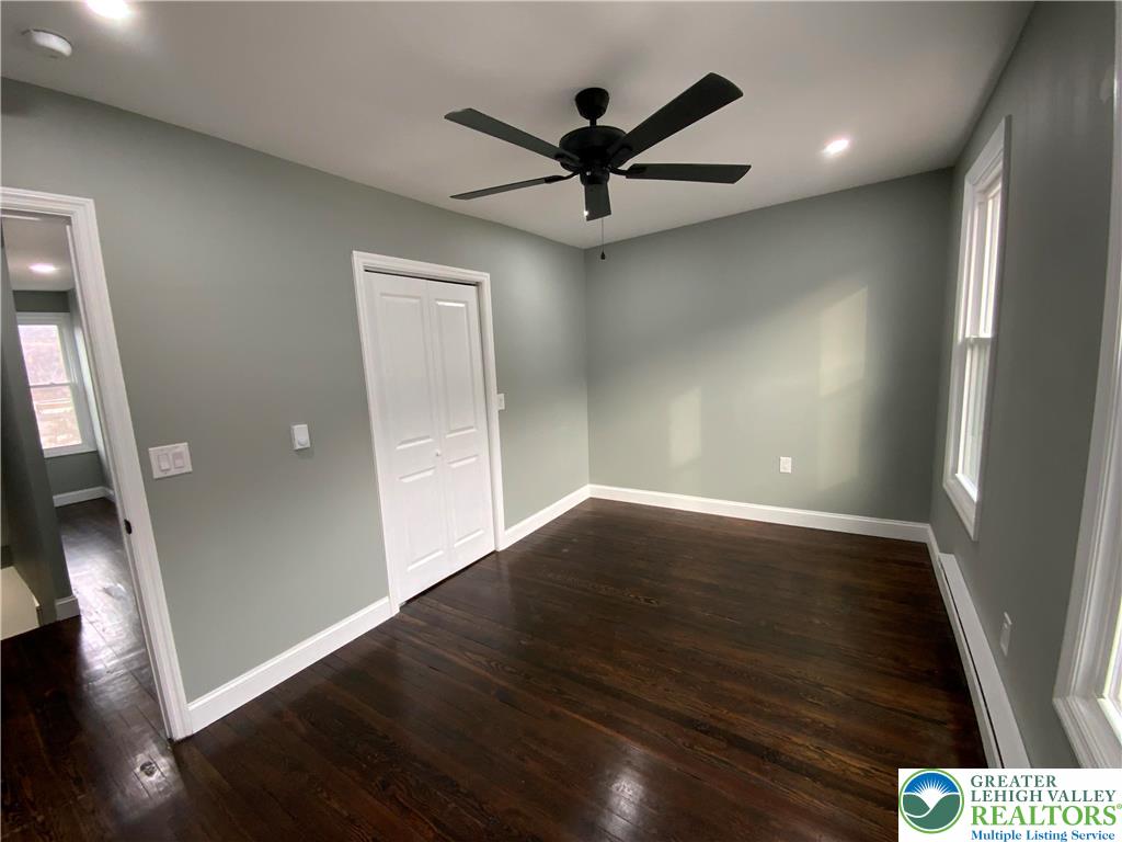 253 East Abbott Street Lansford, PA 18232 - Photo 15 of 43 an empty room with wooden floor and a ceiling fan