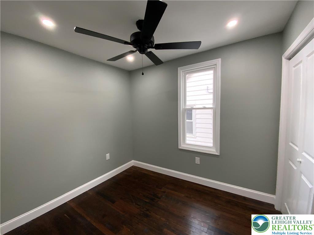 253 East Abbott Street Lansford, PA 18232 - Photo 16 of 43 an empty room with wooden floor fan and windows
