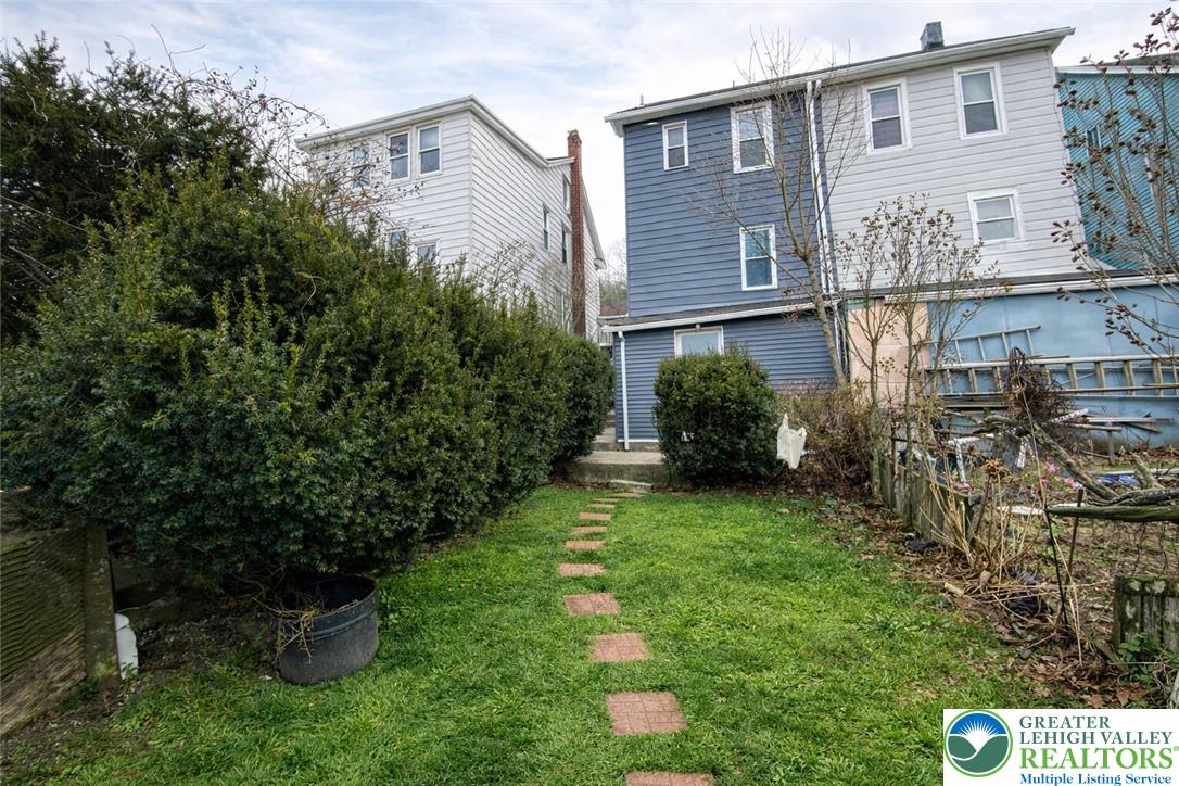 253 East Abbott Street Lansford, PA 18232 - Photo 43 of 43 a view of a house with brick walls and a yard with plants