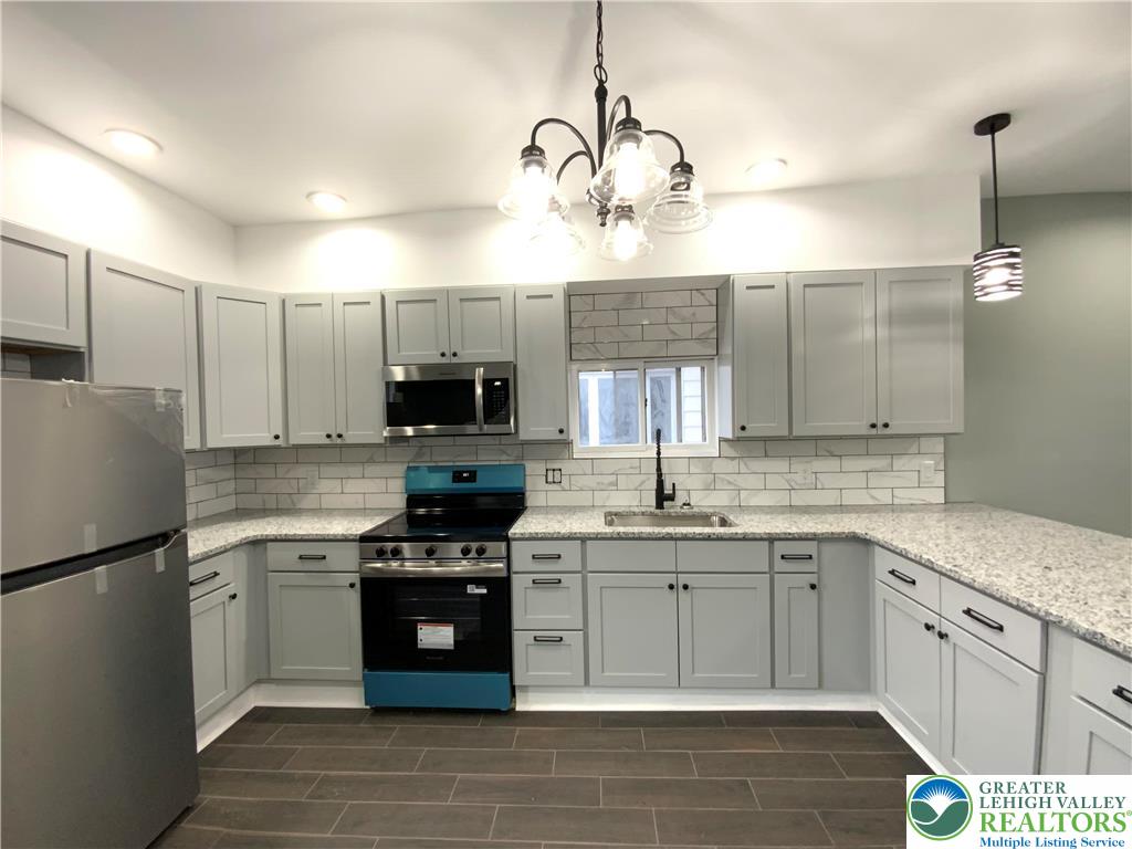 253 East Abbott Street Lansford, PA 18232 - Photo 8 of 43 a kitchen with a sink cabinets and stainless steel appliances