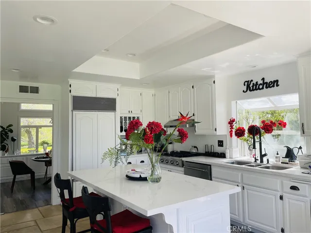 a view of a dining room with furniture and a chandelier