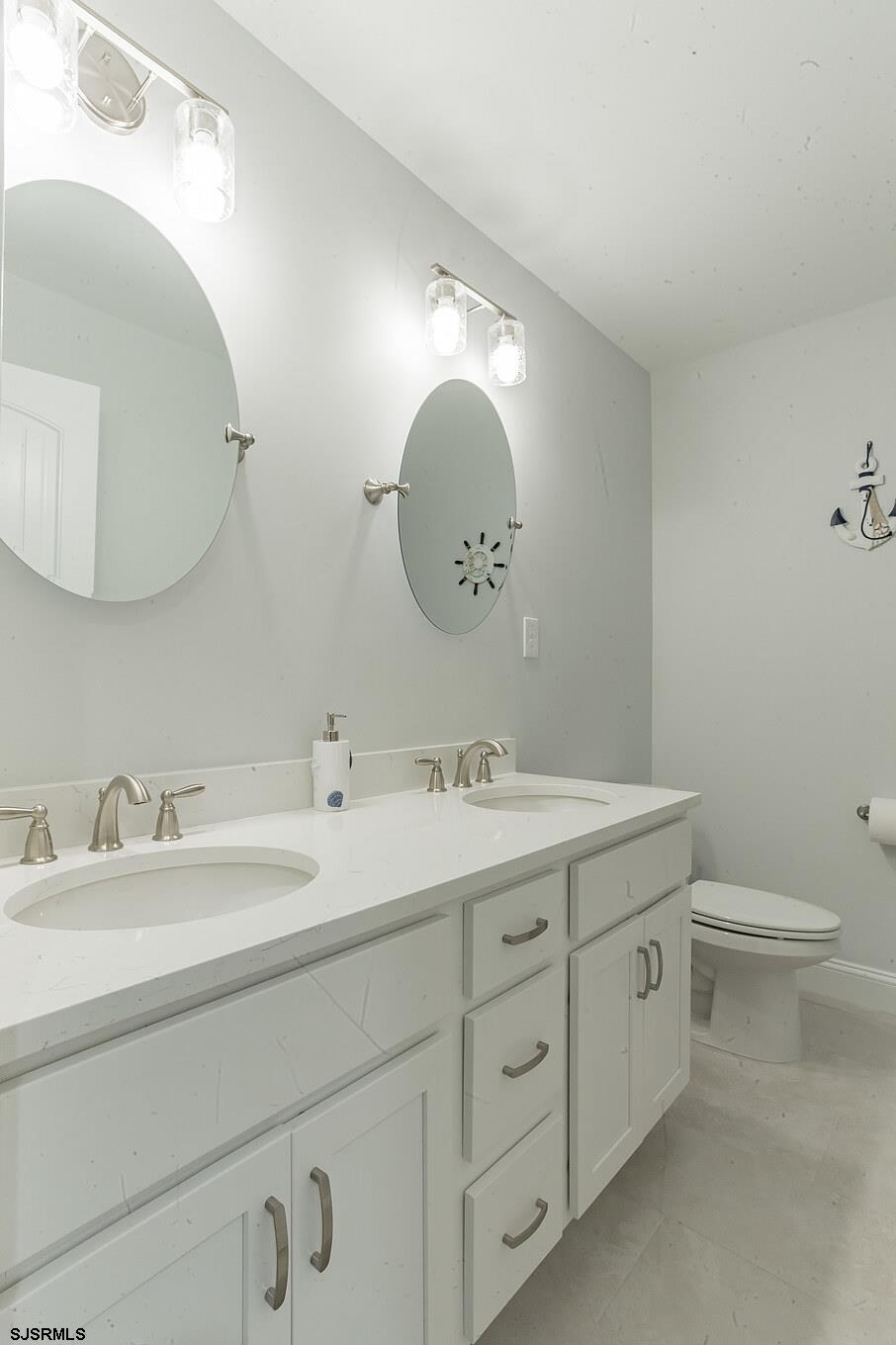 910 Ocean Avenue, Unit C Ocean City, NJ 08226 - Photo 16 of 30 a bathroom with a toilet sink and mirror
