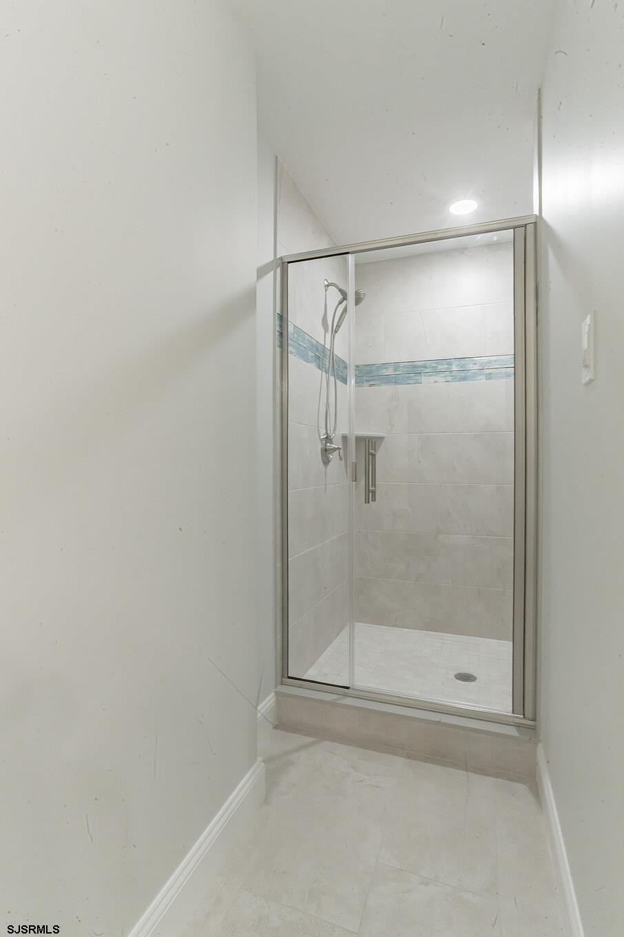 910 Ocean Avenue, Unit C Ocean City, NJ 08226 - Photo 17 of 30 a bathroom with a glass shower door