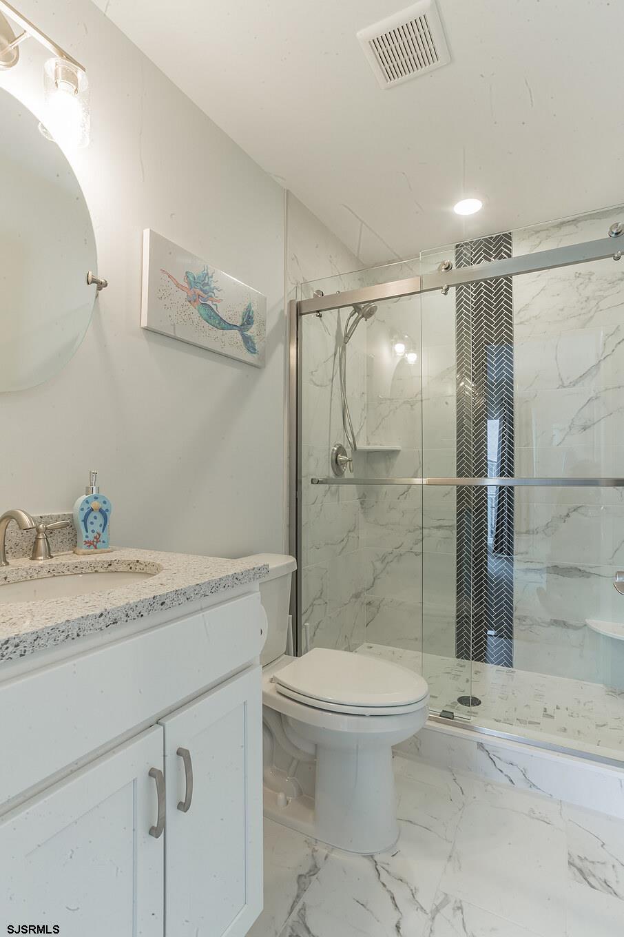 910 Ocean Avenue, Unit C Ocean City, NJ 08226 - Photo 21 of 30 a bathroom with a granite countertop sink toilet and shower