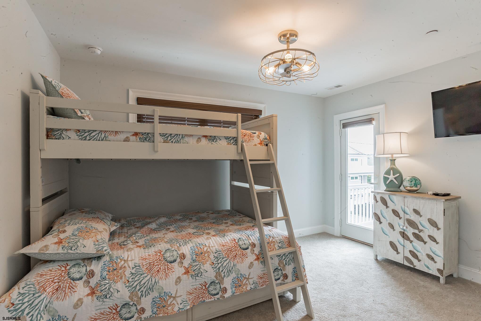 910 Ocean Avenue, Unit C Ocean City, NJ 08226 - Photo 22 of 30 a bedroom with a bed and a tv in it