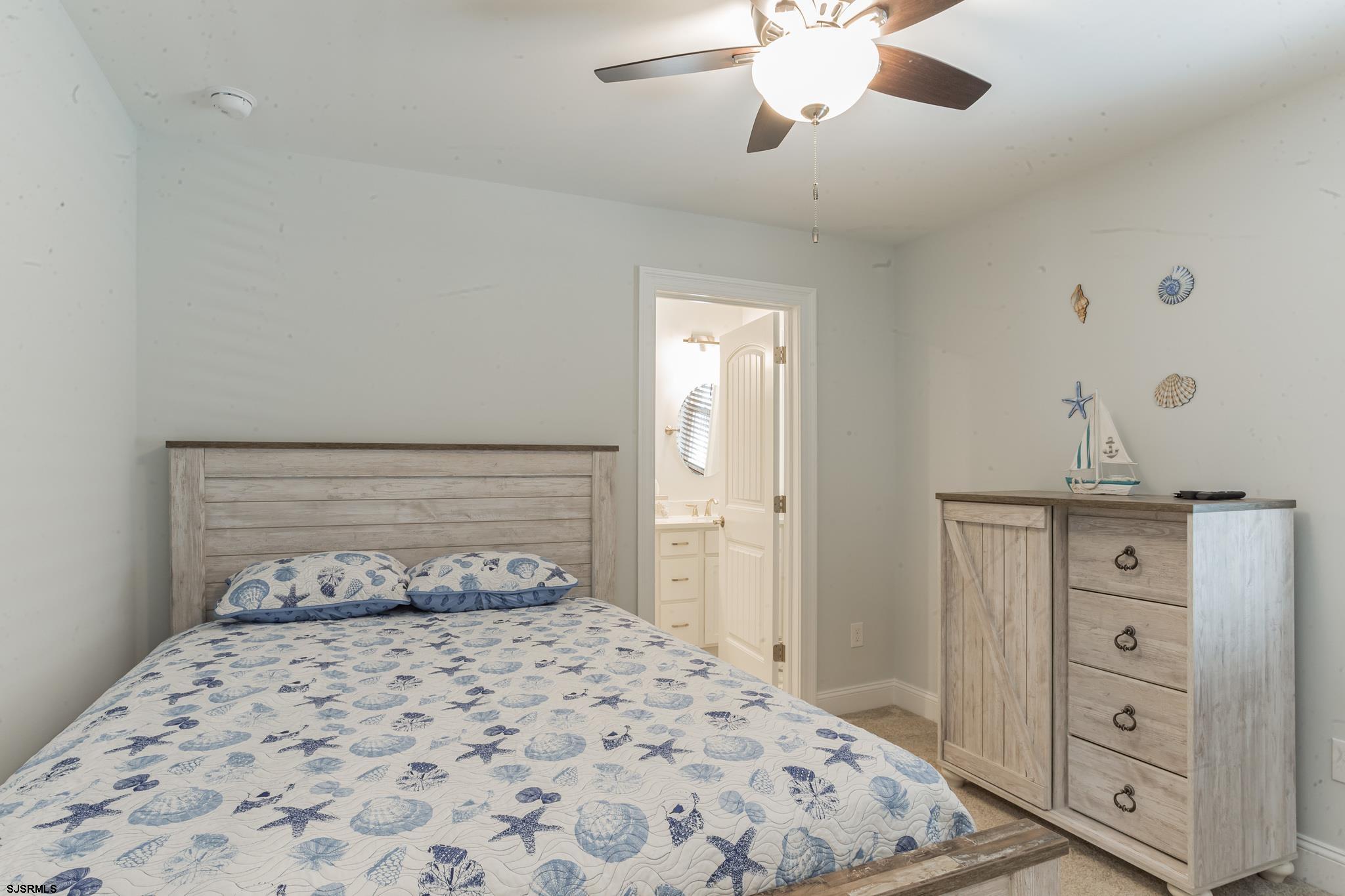 910 Ocean Avenue, Unit C Ocean City, NJ 08226 - Photo 25 of 30 a bedroom with a bed and a dresser