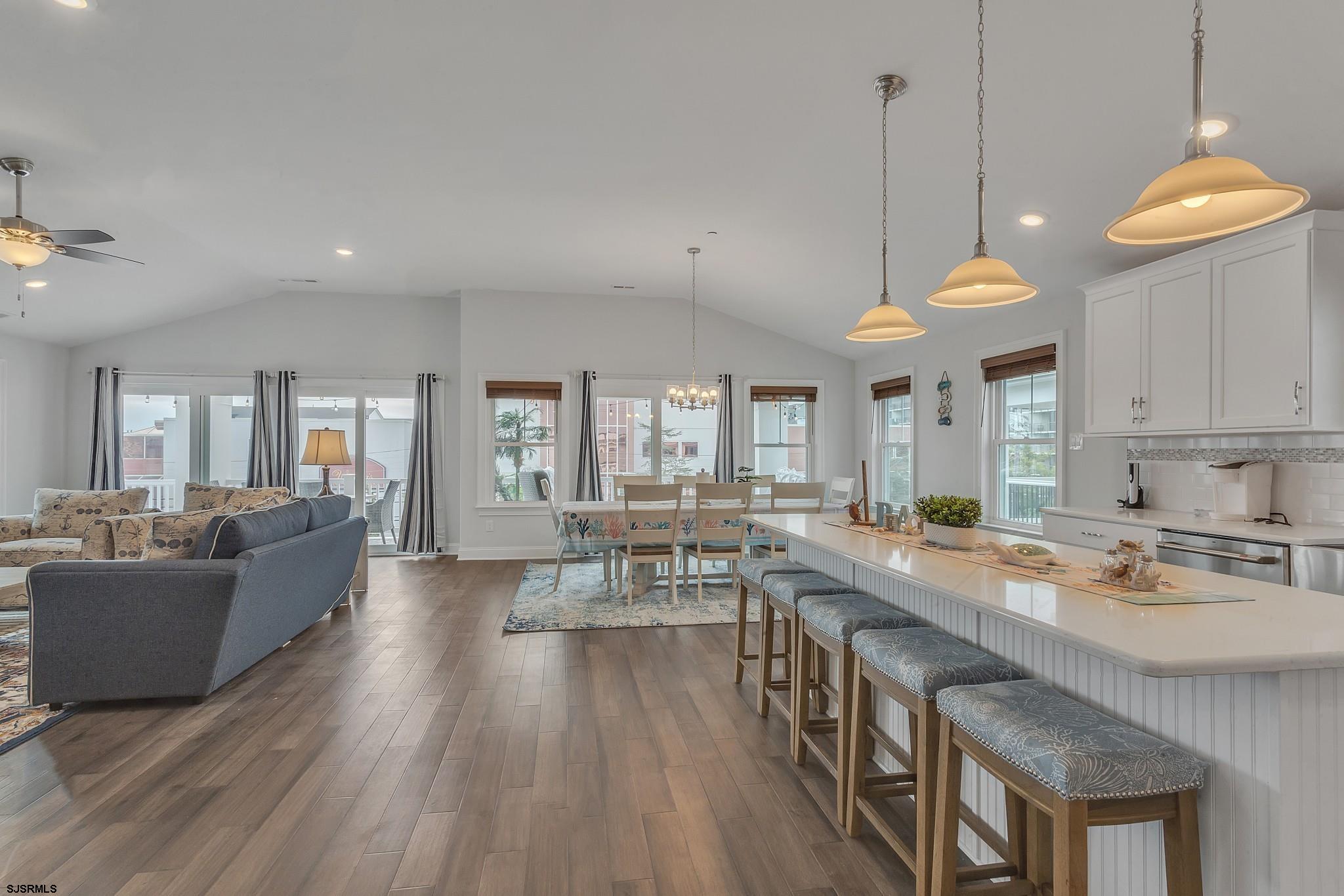 910 Ocean Avenue, Unit C Ocean City, NJ 08226 - Photo 4 of 30 a kitchen with granite countertop a stove a sink a center island a dining table and chairs