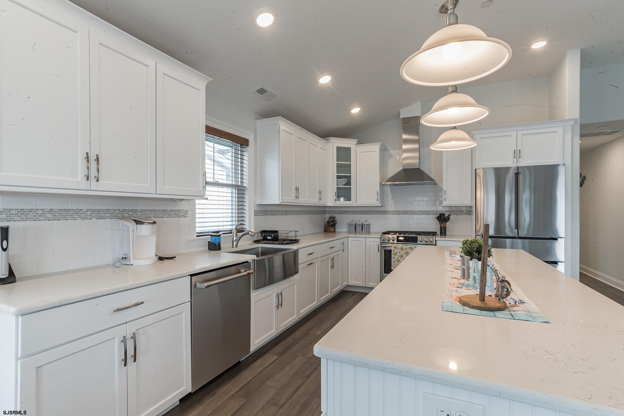 910 Ocean Avenue, Unit C Ocean City, NJ 08226 - Photo 6 of 30 a kitchen with kitchen island granite countertop a white cabinets and refrigerator