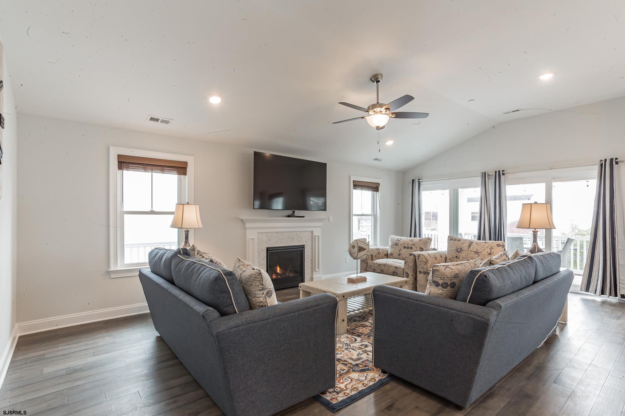 910 Ocean Avenue, Unit C Ocean City, NJ 08226 - Photo 7 of 30 a living room with furniture fireplace and a flat screen tv