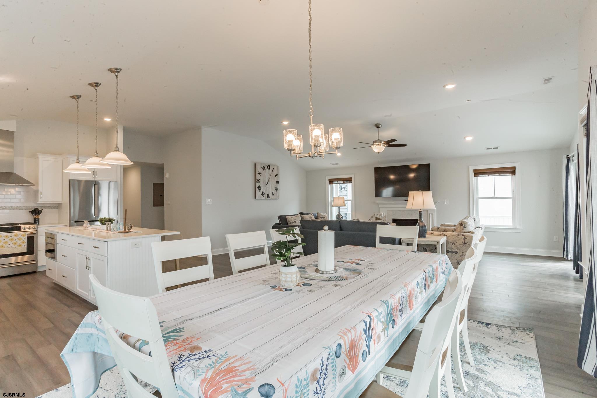 910 Ocean Avenue, Unit C Ocean City, NJ 08226 - Photo 9 of 30 a view of a dining room and livingroom with furniture wooden floor a chandelier