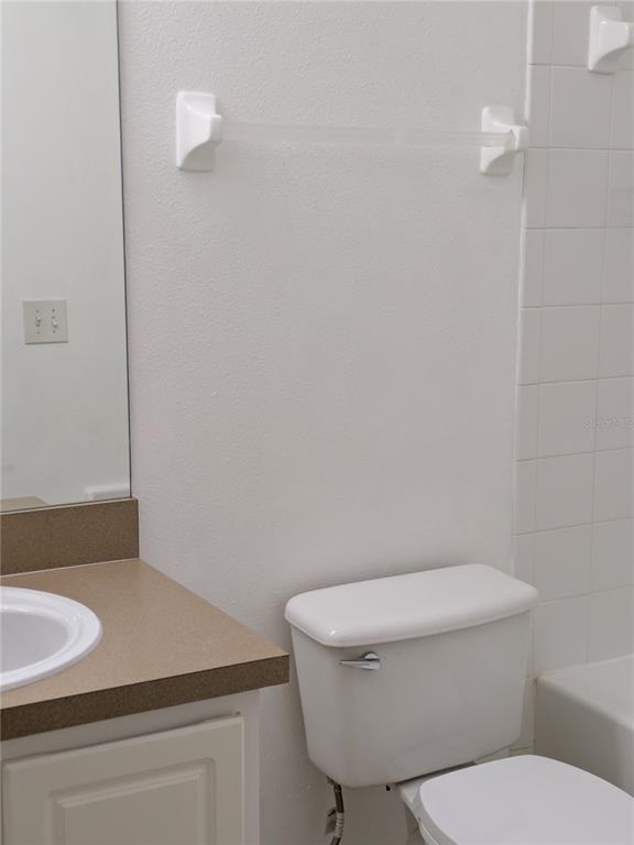 25403 Saddlehorn Way Land O Lakes, FL 34639 - Photo 16 of 18 a white toilet sitting next to a bathroom sink