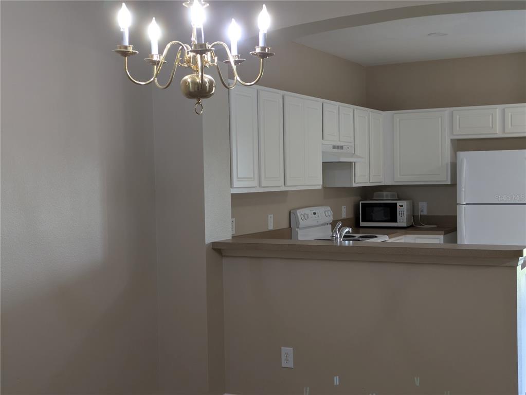 25403 Saddlehorn Way Land O Lakes, FL 34639 - Photo 4 of 18 a kitchen with stainless steel appliances granite countertop a sink a stove a refrigerator and cabinets