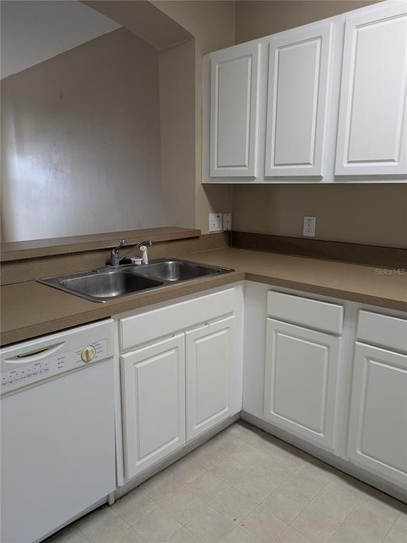 25403 Saddlehorn Way Land O Lakes, FL 34639 - Photo 6 of 18 a kitchen with white cabinets and sink