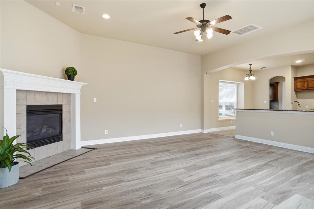 838 San Clemente Irving, TX 75039 - Photo 11 of 24 a view of a livingroom with a fireplace and wooden floor