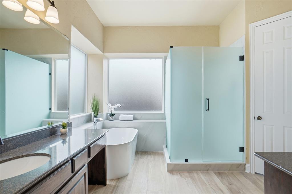 838 San Clemente Irving, TX 75039 - Photo 13 of 24 a bathroom with a double vanity sink a mirror and a shower