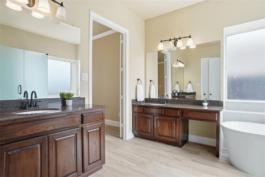 838 San Clemente Irving, TX 75039 - Photo 14 of 24 a kitchen with kitchen island granite countertop a sink and cabinets