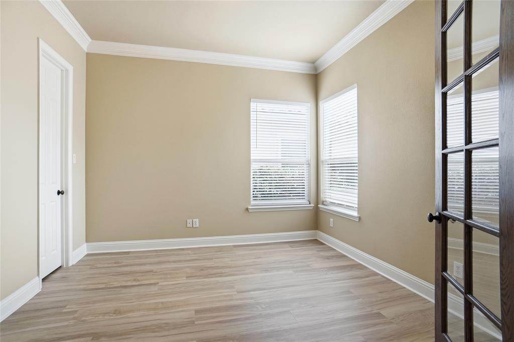 838 San Clemente Irving, TX 75039 - Photo 15 of 24 a view of an empty room with wooden floor and a window