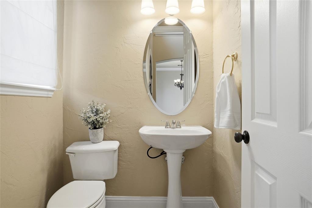 838 San Clemente Irving, TX 75039 - Photo 16 of 24 a bathroom with a toilet sink and mirror
