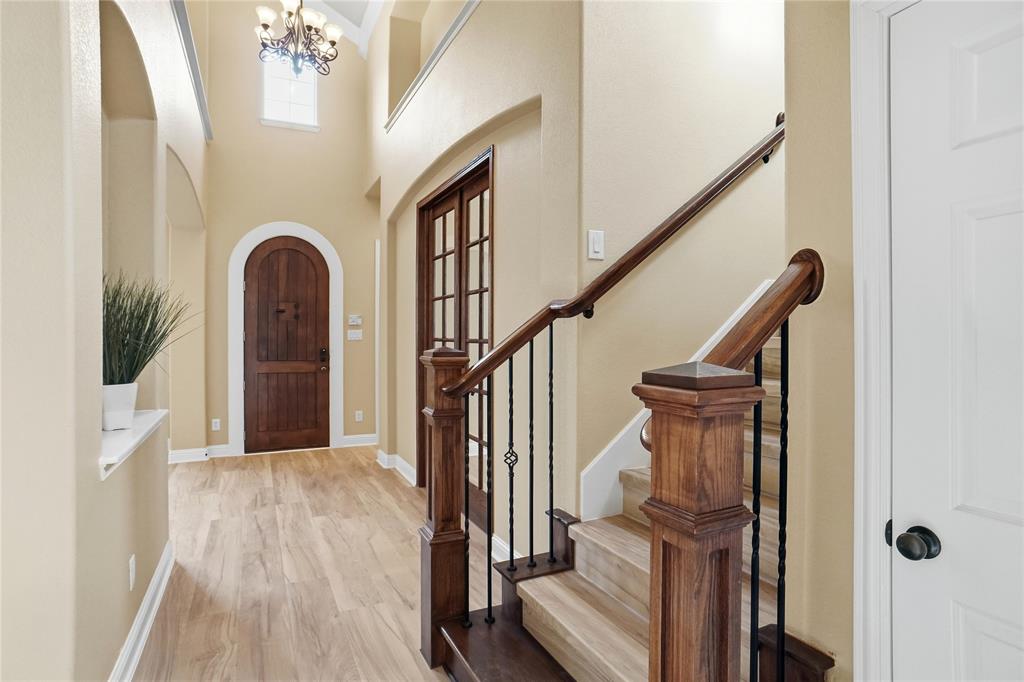 838 San Clemente Irving, TX 75039 - Photo 3 of 24 a view of staircase with wooden floor and a chandelier