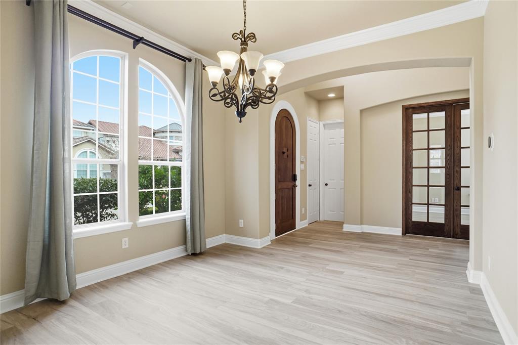 838 San Clemente Irving, TX 75039 - Photo 5 of 24 a view of a livingroom with a chandelier hardwood floor and windows