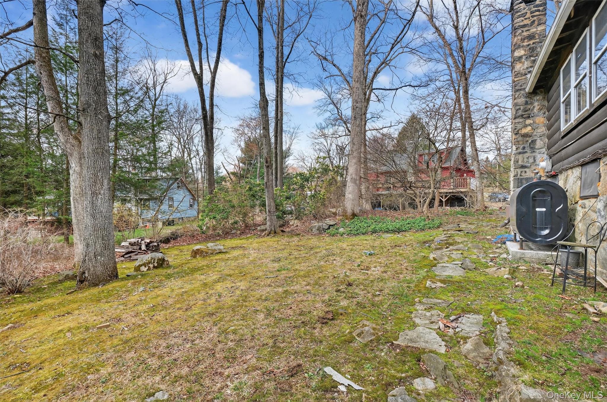 13 Perry Trail Carmel, NY 10512 - Photo 29 of 49 Left side yard with newer above-ground oil tank (2023) and rustic surroundings