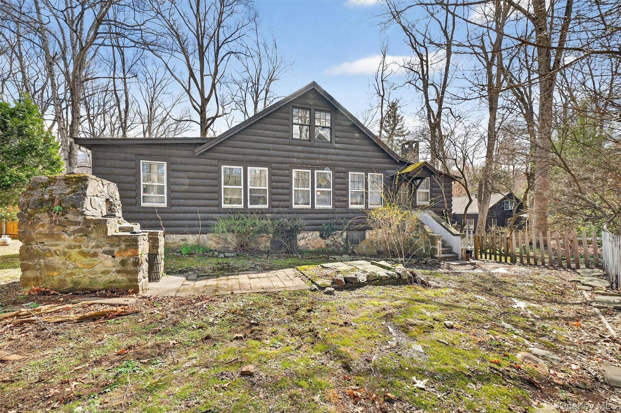 13 Perry Trail Carmel, NY 10512 - Photo 32 of 49 Another view of the backyard featuring the stone fireplace and fenced-in yard